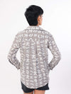 Person wearing a patterned shirt on a white background