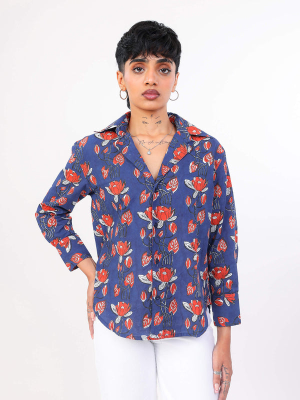 Woman wearing a blue floral patterned shirt on a white background