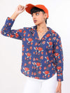 Women wearing a blue floral shirt with orange flowers and an orange cap on a white background