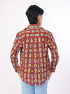 Person wearing a redpatterned shirt on a white background