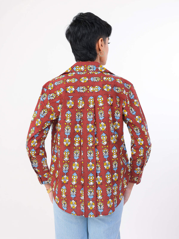 Person wearing a redpatterned shirt on a white background