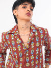 Woman wearing a red patterned shirt against a white background