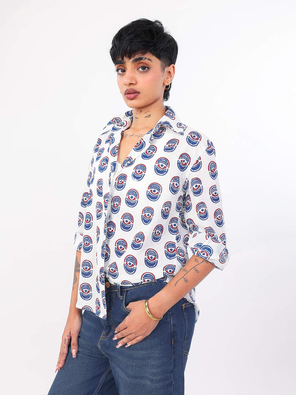 Woman wearing a white evil eye pattern shirt on a white background