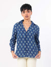 Women wearing a indigo patterned shirt on a white background