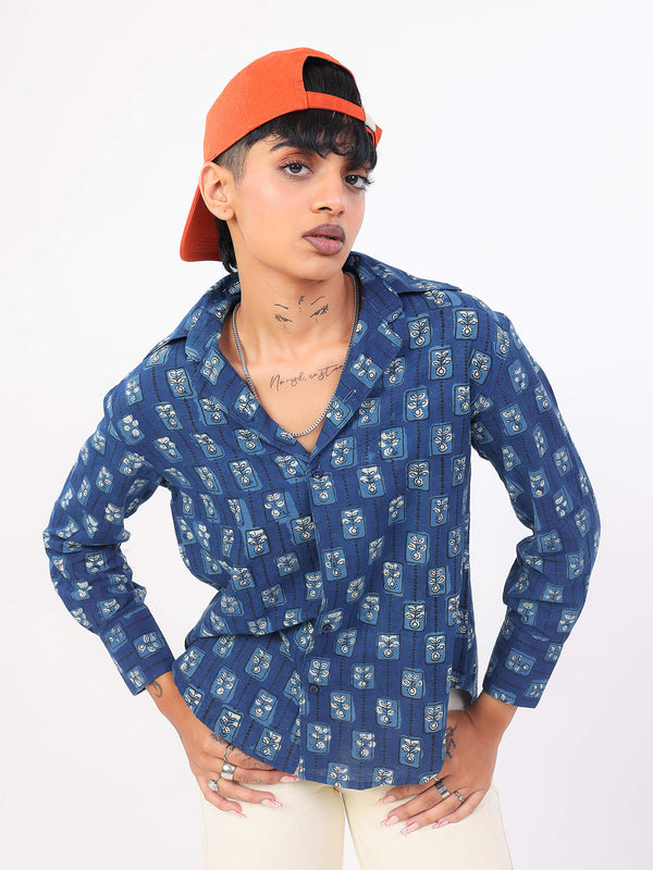 Women wearing a indigo patterned shirt and orange cap on a white background
