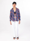 Woman wearing a blue floral shirt on a white background