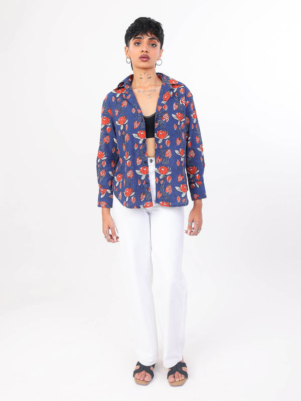 Woman wearing a blue floral shirt on a white background