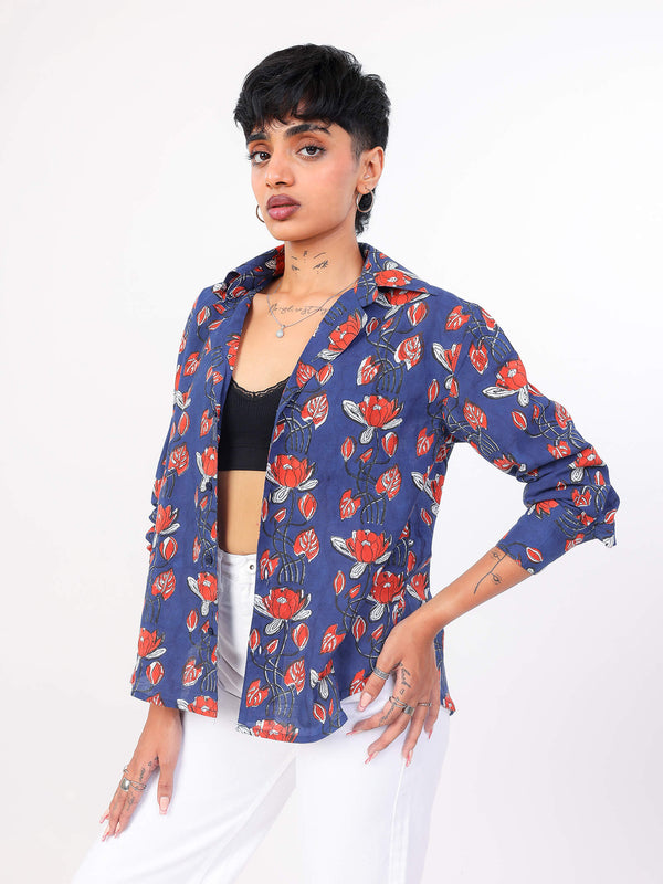 Woman wearing a blue floral patterned shirt on a white background