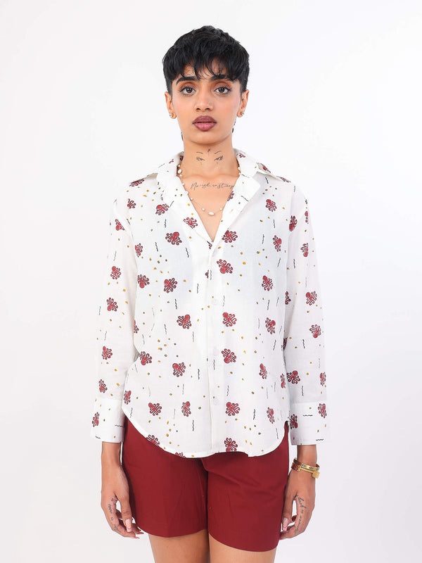 Women wearing a white ocean print shirt and red shorts on a white background