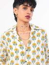 Woman wearing a Sun & Leaf shirt with a plain background