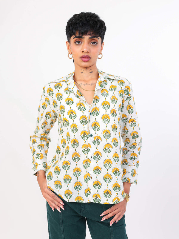 Woman wearing a Sun & Leaf shirt against a white background